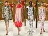 Fire modeller i dekorative blomstrete kjoler går på en catwalk foran en gullfarget bakgrunn.